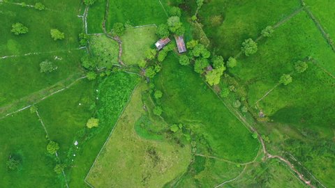 Spring landscape of mountains, mowing meadows and pasiega cabins in the Miera Valley seen from a drone. Cantabria, Spain, Europe