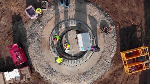 Building process of wind energy farm, the basement of electric power mill under construction. Aerial footage, top view.