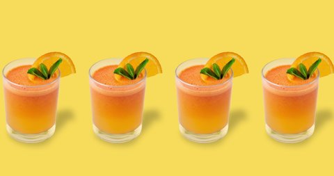 many glasses with orange juice drink and green mint animated on a yellow background. backdrop with a refreshing summer cocktail, copy space. advertising template for menu of cafe and restaurant