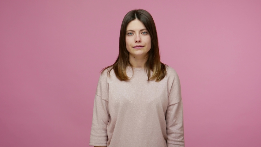 I know how to earn! Cunning smart woman smiling slyly, having idea about big profit and showing money gesture, imitating to scatter cash, body language. indoor studio shot isolated on pink background | Shutterstock HD Video #1054912607