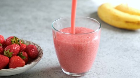 Pouring Delicious Raw Strawberry Smoothie In Glass. Healthy Refreshing Vegan Summer Cocktail