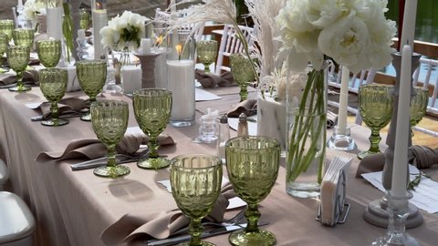Beautiful wedding decor, all decorated in a white style. Chiavari chairs, candles in candlesticks, lake shore.