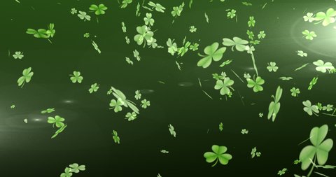 Animation of St Patricks Day multiple shimmering floating green shamrocks with spots of light on glowing green background. Celebration of Irish culture concept digitally generated image.