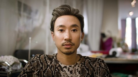 Stylish fashion designer portrait. Handsome and authentic creative portrait. Asian man shot in slow-motion and in 4k. 