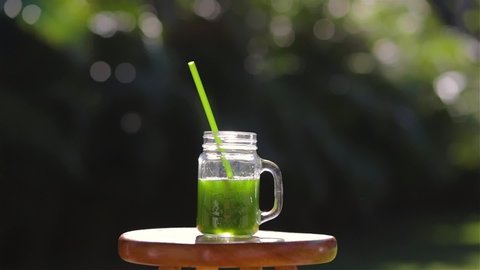 Portrait of female drinking green juice detox cocktail. woman drinking fruit smoothie . Fitness and healthy lifestyle concept.