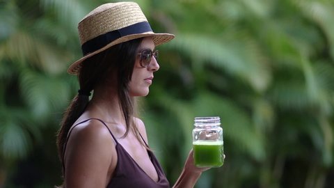 Portrait of female drinking green juice detox cocktail. woman drinking fruit smoothie . Fitness and healthy lifestyle concept.