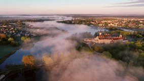 amazing dawn in the foggy Nesvizh, Fog over the river. Nesvizh. Ancient castle . Belarus