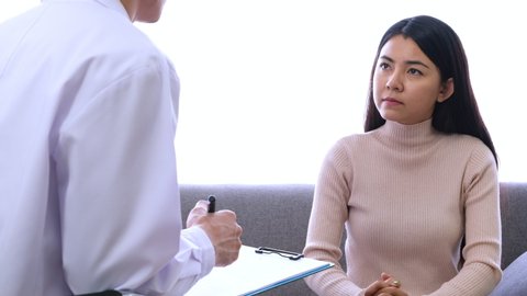 Woman talking with psychiatric doctor about stress after covid-19 spreading,mental health concept.