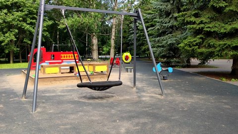 swinging swings on the Playground in summer