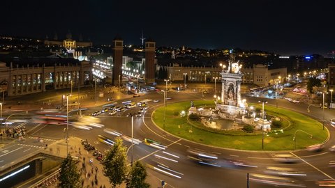 Barcelona, Spain, zoom out timelapse view of traffic around Plaza Espanya historical square at night.