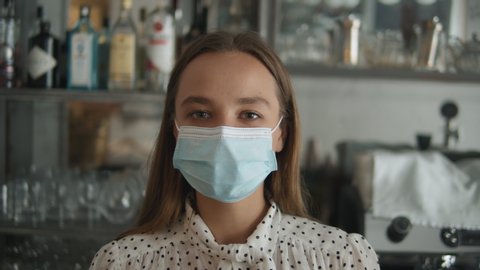 Coffee Shop restaurant Woman Owner Working With Face Mask, Open After Lockdown coronavirus Quarantine is over. Girl business owner waiter waiting customers, first days after covid - Βίντεο στοκ