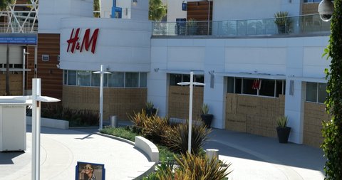 Long Beach, CA/USA - June 13, 2020: H & M Store at the posh Pike Outlets boarded up after it was looted during Black Lives Matter protests
