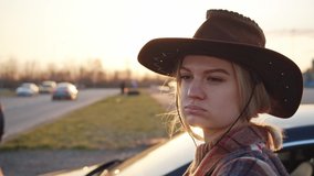 Pretty young western girl posing for polaroid instant camera at sunset. Cheerful blonde cowboy woman taking retro selfie pictures near parked car. Memories concept. - Powered by Shutterstock - Get 15% off with code: PIKWIZARD15