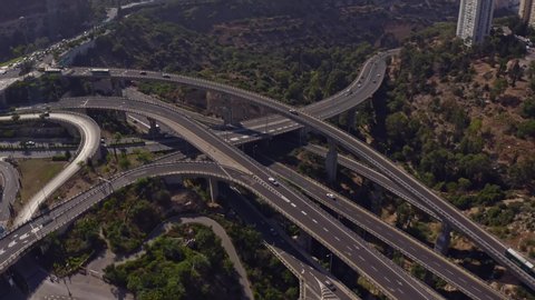 Huge highway road interchange near the Haifa transportation underground caves, aerial drone view 4k