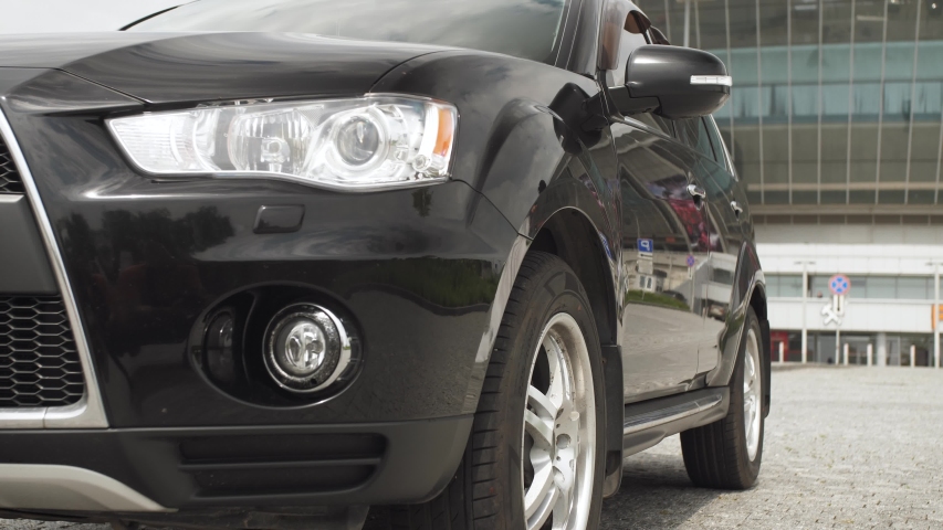 woman opens the car door and gets in the car