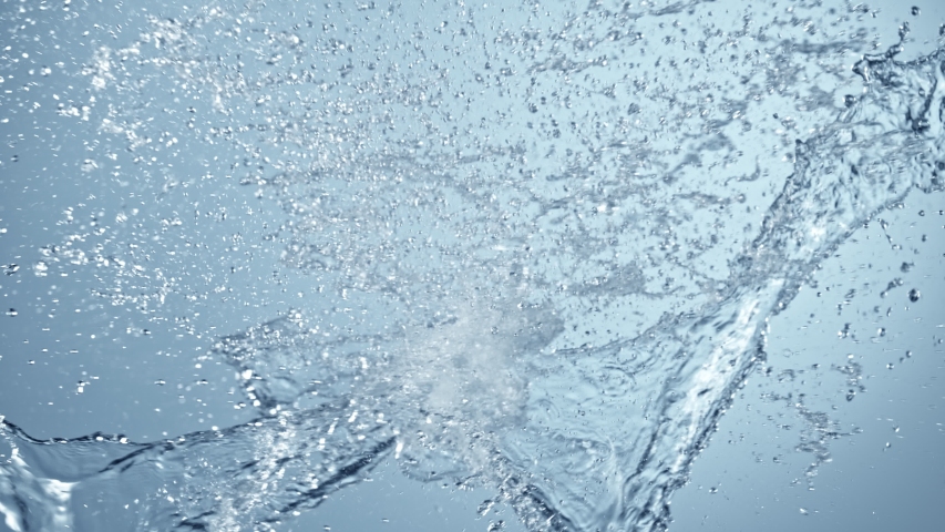 Super Slow Motion Shot of Side Water Splash on Blue Gradient Background at 1000fps.