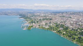 Inscription on video. Lausanne, Switzerland. Flight over the central part of the city. The coast of Lake Geneva. Glitch effect text, Aerial View
