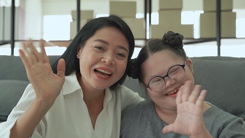 Mother and daughter with down syndrome, video call looking for father
