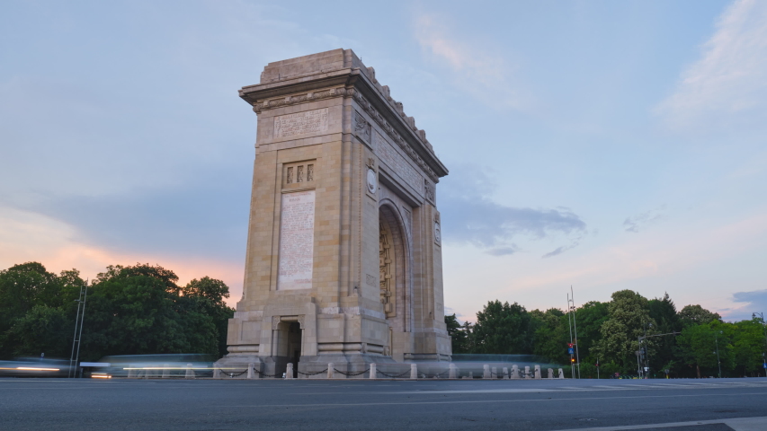 Arch of Triumph in Bucharest, Romania. Day to night looping hyperlapse in the evening, at blue hour, with car lights trails. City life, urban scene, transport, cityscape, sightseeing, travel concept. Royalty-Free Stock Footage #1054965566