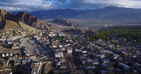 Epic down-looking aerial view of the iconic Leh palace, capital of Ladakh, with its mountain range, valley, and traditional architecture, famous travel destination in India