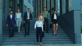 Professional company staff walking downstairs at office building. Successful and ambitious young team of co-workers and female boss. Cooperation. Career. - Powered by Shutterstock - Get 15% off with code: PIKWIZARD15