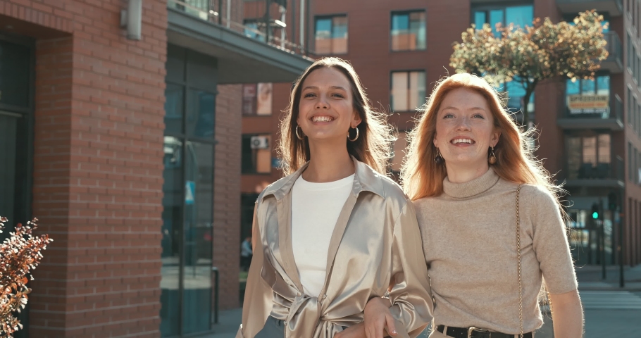 Happy and Smiling Girls Having a Walk in the City and Enjoying their youth and Free time. Having fun and Talking to each other while walking in the Town. Having stylish Outfits and charming Appearance | Shutterstock HD Video #1054990829