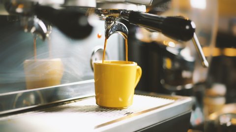 Espresso machine pouring coffee. Close up, looping cinemagraph of espresso dripping into coffee mug. Perfect loop, 4K.