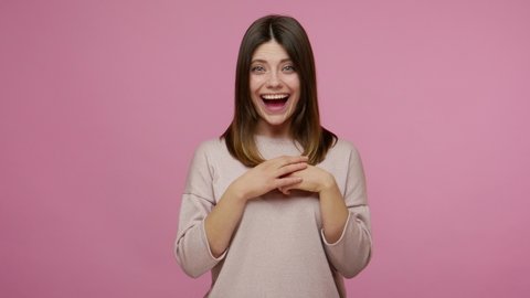 Extremely excited brunette woman opening her mouth in amazement after hearing unbelievable news, looking surprised by sudden great success, shocked face. indoor studio shot isolated on pink background