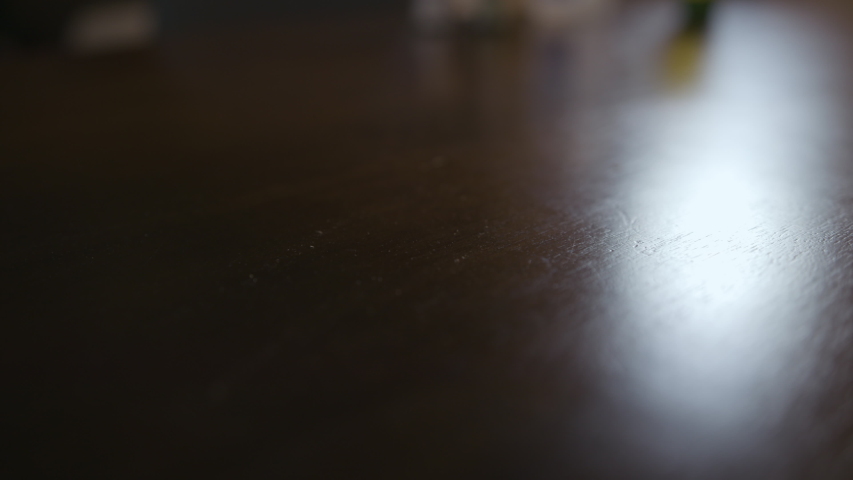 Close up of a bible being put down on a table, and pages being flipped through
