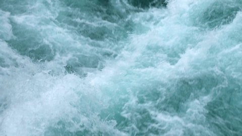 Close up shot of the aggressive river leading up to Huka Falls in New Zealand.