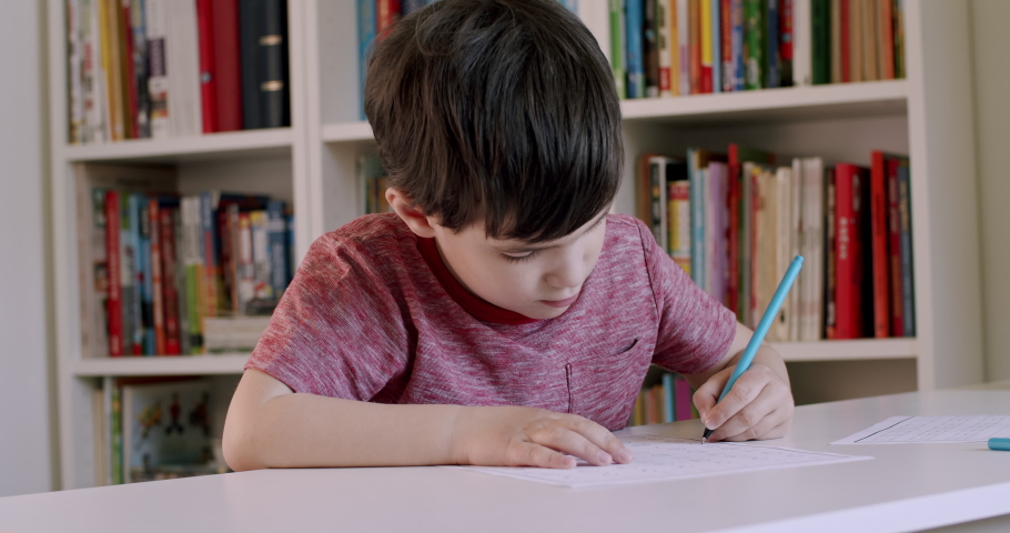 Left handed preschooler child writing with pen. Little boy holding pen in his left hand and practising writing. Royalty-Free Stock Footage #1055030912