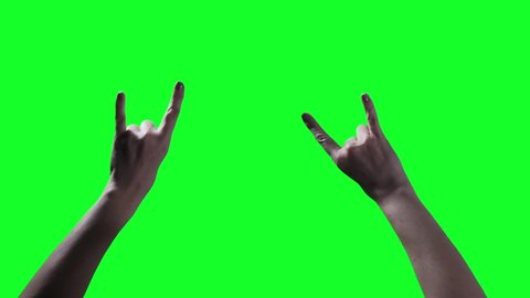 Woman Hand showing Devil Horns Hand Sign against Green Background. Close Up. You can replace green screen with the footage or picture you want. You can do it with “Keying” effect in After Effects.