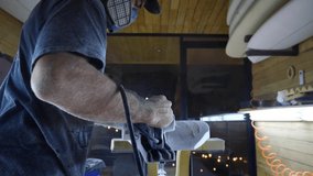 Surfboard manufacturing, Shaper sands the surfboard with a tool. Concept of small business owner, skilled professional, occupation & job in America.  - Powered by Shutterstock - Get 15% off with code: PIKWIZARD15