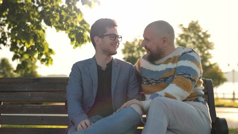 Gay Marriage Proposal Concept. Adorable Boyfriend Gifts a Beautiful Shiny Wedding Ring to His Cute Fiance. Surprised Partner is Extremelly Happy and Hugs His Queer Friend. Relationship Goals.