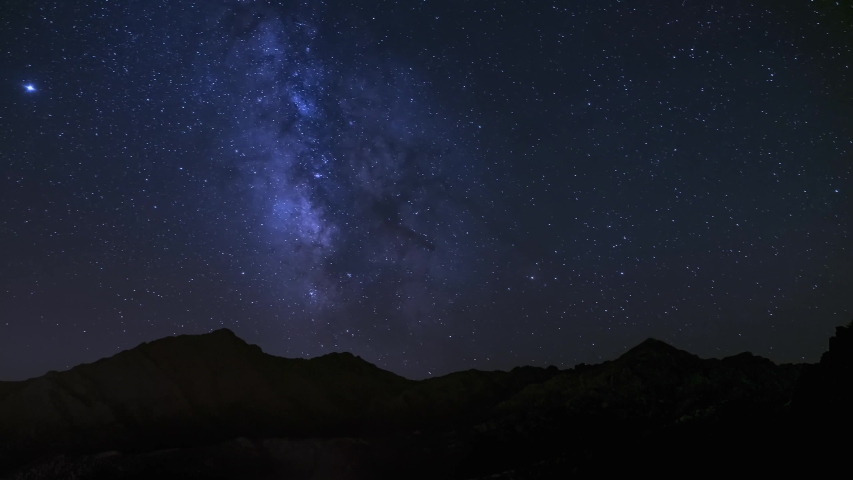 Day to night to day holy grail time-lapse of the Milky Way passing over the mountains of Monte Padro, Monte Grosso and Monte San Parteo in Corsica Royalty-Free Stock Footage #1055036387