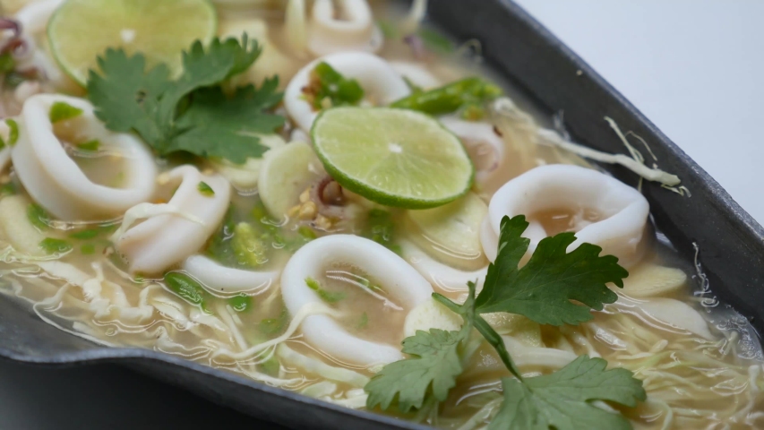 Close-Up Footage of Hot and Sour Squid in Chilli, Garlic and Lime Soup
