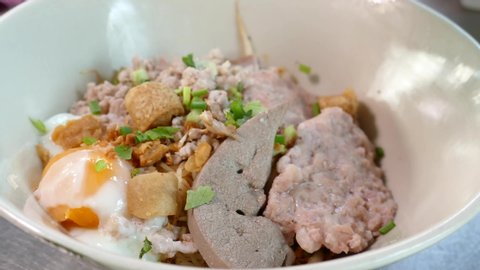 Close-up Footage of Thai Styled Egg Noodles With Minced Pork Cake and Pork Liver, Thailand Popular Street Food
