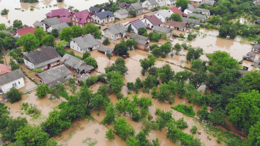 Environmental disaster and climate change. Aerial view river that flooded the city and houses. Flooded houses in the water. Royalty-Free Stock Footage #1055043659