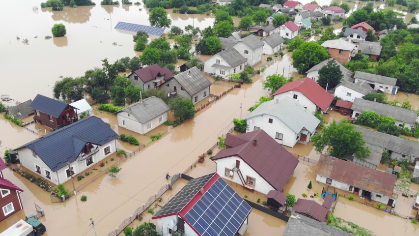 Environmental disaster and climate change. Aerial view river that flooded the city and houses. Flooded houses in the water. | Shutterstock HD Video #1055043659