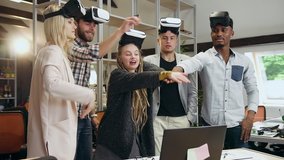 Good-looking contented cheerful mixed race friends with augmented reality headset on their heads stacking hands making unity gesture and raised up - Powered by Shutterstock - Get 15% off with code: PIKWIZARD15