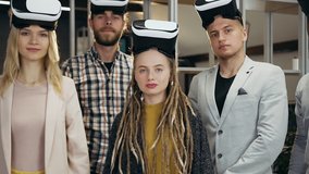 Attractive satisfied modern experienced 30s multiracial office people with augmented reality goggles on their heads looking at camera with crossed hands - Powered by Shutterstock - Get 15% off with code: PIKWIZARD15