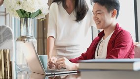 asian wife serving coffee and embracing asian husband casual dress Using Laptop Computer in dining room work at home concept - Powered by Shutterstock - Get 15% off with code: PIKWIZARD15