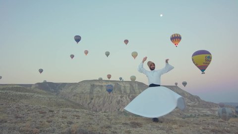Cappadocia, Turkey - March 25 2020. Balloon and whirling dervish dance in Cappadocia