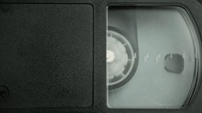 The right side of the VHS cassette. a film reel spins