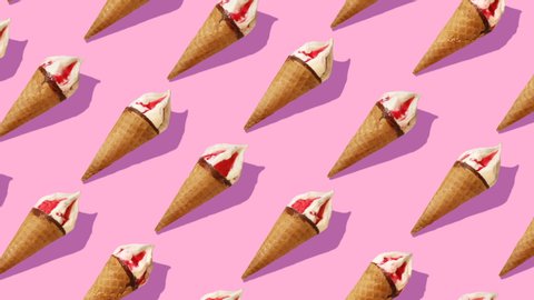 Beautiful background from  of large group of  ice cream. 
Appetizing ice cream cones rotating on pink background.
Flat lay, top view. Isometric view. Seamless loop video. 