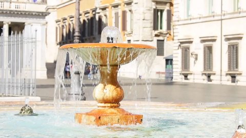 Rome, Italy orange colorful water fountain in Piazza seamless cinemagraph loop in historic city street with drops spraying splashing on sunny summer day