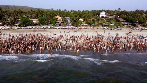 Arambol Goa India Freak Parade Carnival at the sunset beach drone fly over. High quality FullHD footage