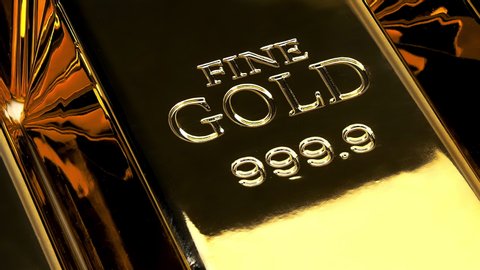 Camera panning slowly over solid Gold Bars with the etching “Fine Gold - 999.9” engraved into them.