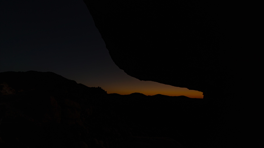 Time lapse tracking shot of sunrise through boulder in Southern Arizona Royalty-Free Stock Footage #1055063150