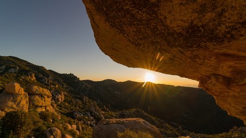 Time lapse tracking shot of sunrise through boulder in Southern Arizona